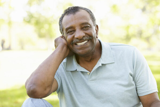 Older African American male outside smiling
